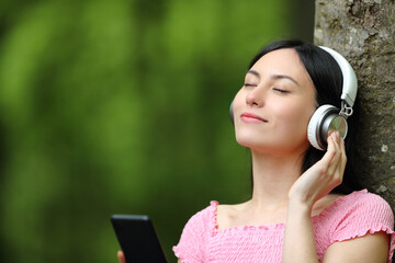Korean woman listening to music with headphones