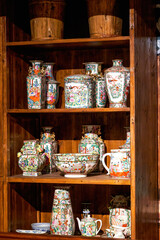 Carved mahogany cabinet and porcelain vase in Lingnan style, Guangdong, China