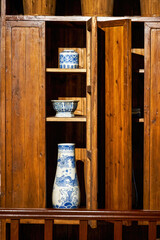 Carved mahogany cabinet and porcelain vase in Lingnan style, Guangdong, China