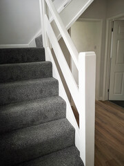 Newly renovated hallway and staircase with fresh paint and carpets - ready for sale or rental on the UK market.