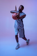 Strong basketball player hand holds ball
