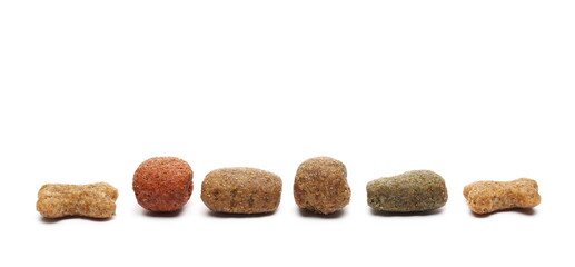 Dog food pile, dry granules for pets arranged in line, row isolated on white background
