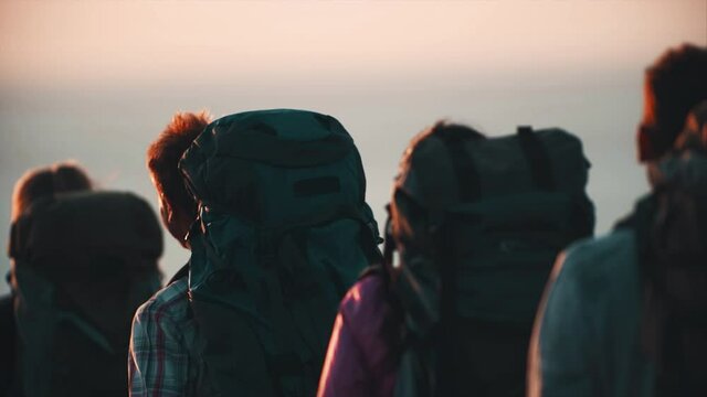 The four tourists traveling with backpacks. slow motion