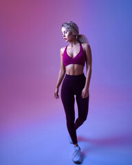 Obraz na płótnie Canvas Young athletic woman, neon background