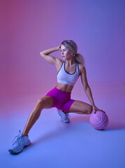 Fototapeta na wymiar Athletic sportswoman doing exercise with ball