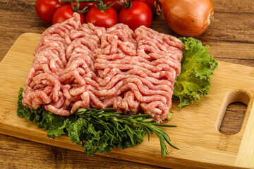 Raw pork minced meat over board