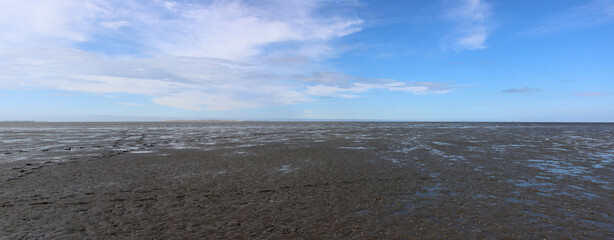 Panoramic view of beautiful Wadden Sea near Schillig in Germany including the island of Minsener Oog in North Sea in summer.