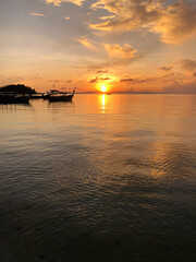 Fototapeta na wymiar Silhouette Longtail boat on the sea at sunrise, Satun Thailand.