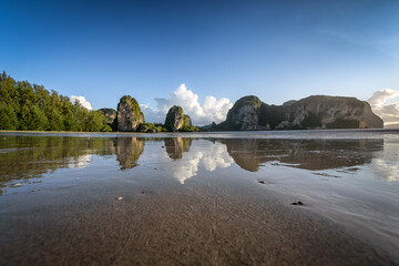 Fototapeta premium The beautiful scenery of the Rajamangala beach with the reflection on a clear blue sky day at Trang province, Thailand.