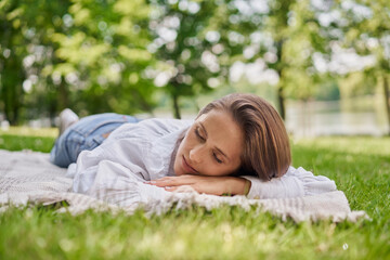 Woman sleeping in the park during summer