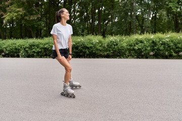 Smiling woman rollerblading in park