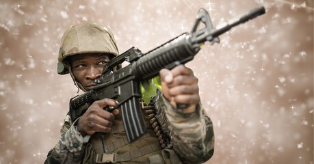 Composition of soldier firing gun, against motion blur brown background