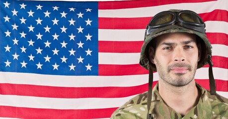 Composition of smiling male soldier wearing helmet, against american flag