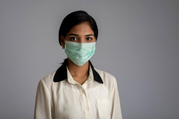 Closeup portrait of a young girl or woman wearing a medical or surgical mask
