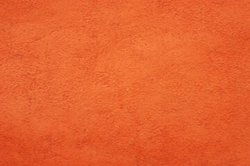 Orange wall background with rustic plaster texture.