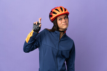 Teenager cyclist girl with fingers crossing and wishing the best