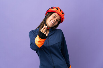 Teenager cyclist girl making money gesture