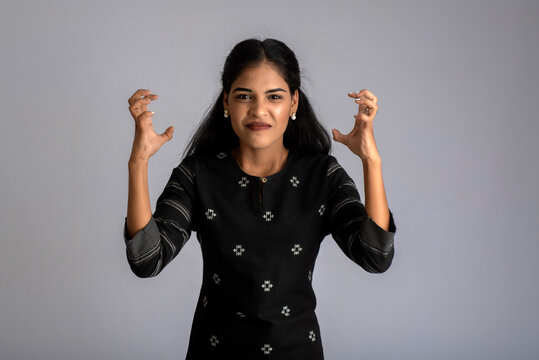 Portrait of a young girl posing on gray background