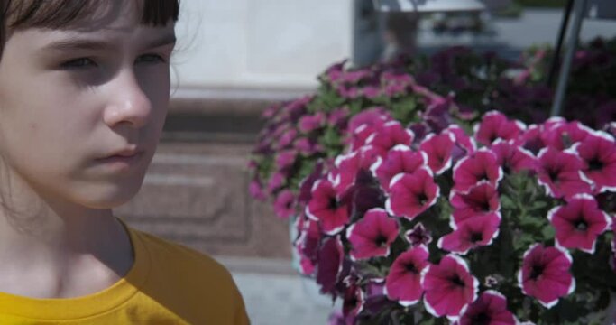 Teen with allergy disease. A view of a stressed teen with seasonal allergy attack by the flowers.