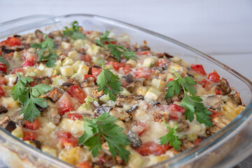 diet vegetable casserole with tomatoes, eggplant and pepper, baked over cheese. Vegetarian casserole with zucchini, mushrooms and cherry tomatoes.