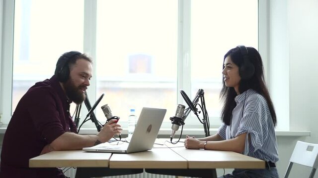 Man interviewing woman influencer, recoding audio on mic for live radio show Spbd. Announcer