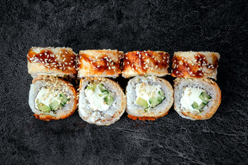 Philadelphia sushi roll set with ell fish and cream cheese. Japanese dish of unagi roll with rice, top view