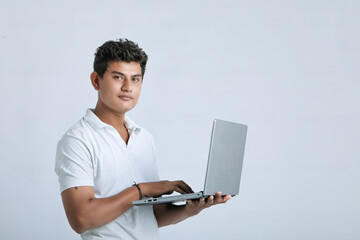 young indian man using laptop.