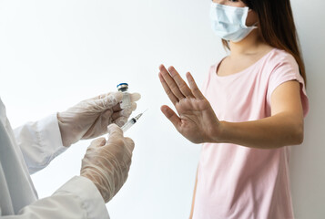 Asian woman wearing surgical mask refuse nurse injection or vaccination. Rejection of the vaccine,...