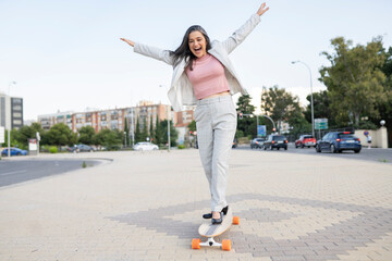 Beautiful senior woman riding with skateboard