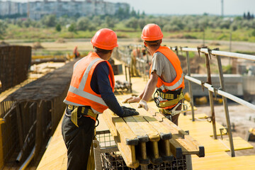 Workers at the construction site of a transport bridge 