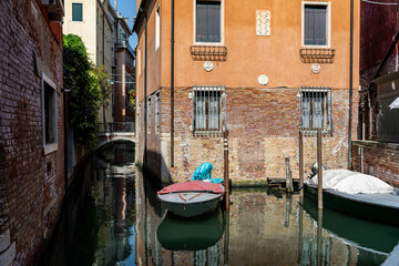 Fototapeta na wymiar A Water Canal (so-called Riva) in Venice, Italy. These waterways are the main means of transport in the city