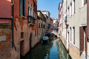 Fototapeta na wymiar A Water Canal (so-called Riva) in Venice, Italy. These waterways are the main means of transport in the city