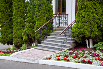 a granite staircase with a wrought iron railings, entrance steps, exit to the backyard with a...