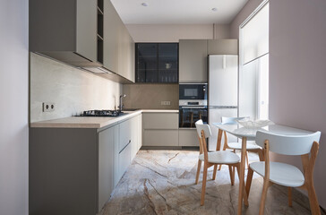 modern scandinavian minimalist kitchen in monochrome color with a showcase and a built-in oven and microwave at waist level and a dining area