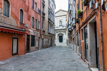 Fototapeta na wymiar Empty narrow street in Venice, Italy