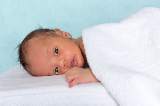 Innocent baby under towel