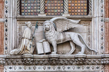 Winged lion, a symbol of the city, with the Doge, on the Doge's Palace (Palazzo Ducale), San Marco, Venice.