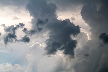 Fototapeta na wymiar Dark storm clouds. Sunlight breaks through clouds. Dramatic sky.