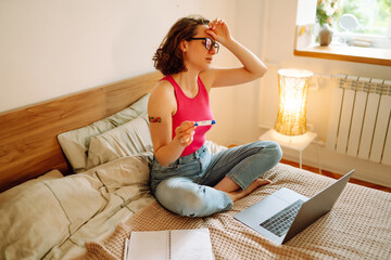 Woman blogger videotapes her vlog at home and speaking about Vaccine for covid-19. Making video call to friends and parents. Medical, pharmacy and healthcare, Social media and quarantine.