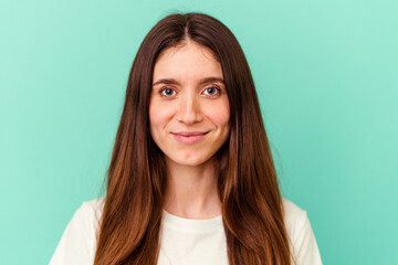 Fototapeta premium Young caucasian woman isolated on blue background