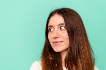 Fototapeta premium Young caucasian woman isolated on blue background