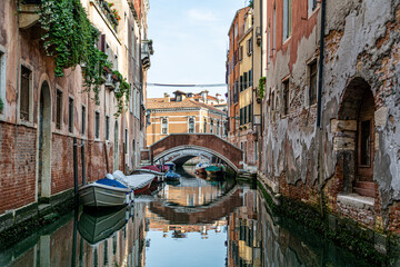 Romanic view of a Water Canal (so-called Riva) in Venice, Italy. These waterways are the main means of transport in the city