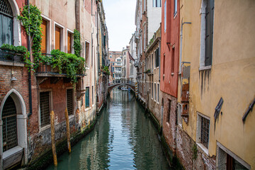 Obraz na płótnie Canvas Romanic view of a Water Canal (so-called Riva) in Venice, Italy. These waterways are the main means of transport in the city