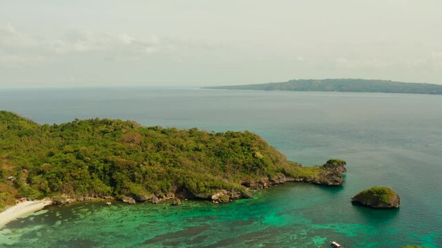 Tropical sandy beach near the blue lagoon and corall reef, aerial view Boracay, Philippines. Ilig Iligan Beach. Summer and travel vacation concept.