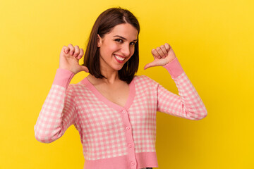 Young caucasian woman isolated on yellow background feels proud and self confident, example to follow.