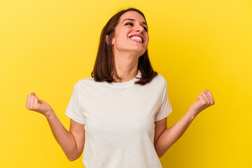 Young caucasian woman isolated on yellow background relaxed and happy laughing, neck stretched showing teeth.