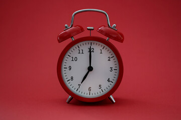 Closeup of alarm clock on red background