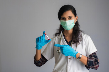 Woman Doctor holding a test tube with blood sample for coronavirus or 2019-nCoV analyzing. © Dip Photography