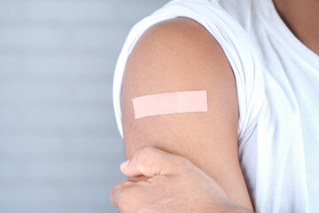 adhesive bandage on young man's arm 