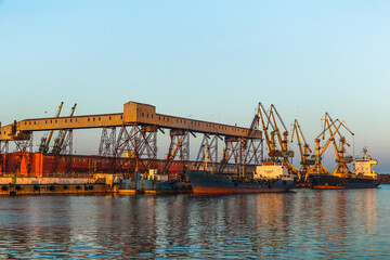 A dry cargo ship and a tanker ship are standing at the port of Constanta Romania and are being...